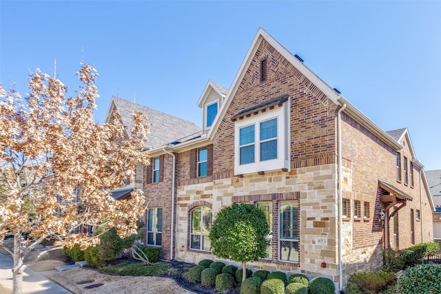 view of front of house featuring brick siding and stone siding