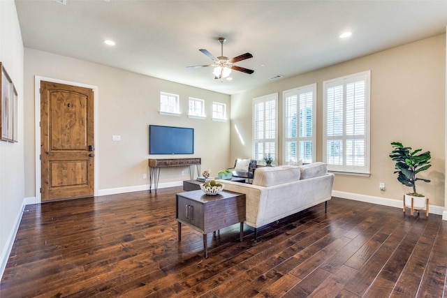 living area featuring plenty of natural light, baseboards, visible vents, and dark wood-style flooring