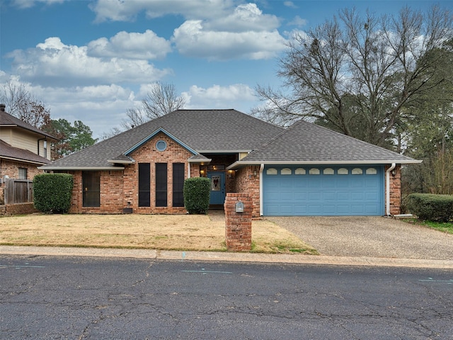 view of front of house with a garage and a front yard