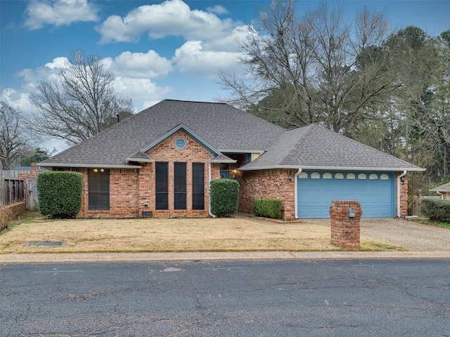 view of front of property featuring a garage and a front yard