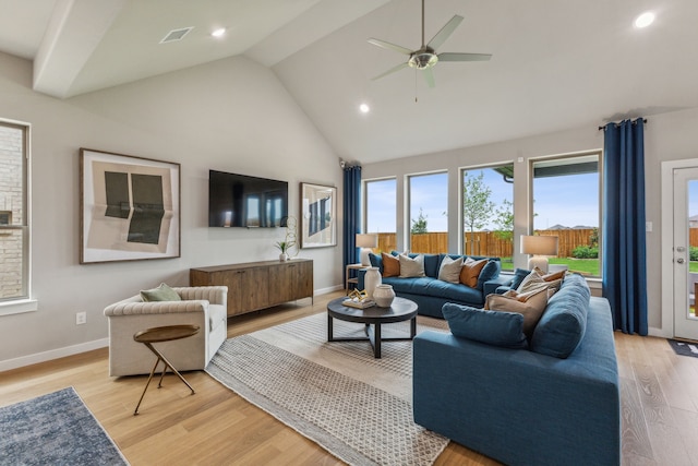 living room featuring ceiling fan, high vaulted ceiling, and light hardwood / wood-style flooring