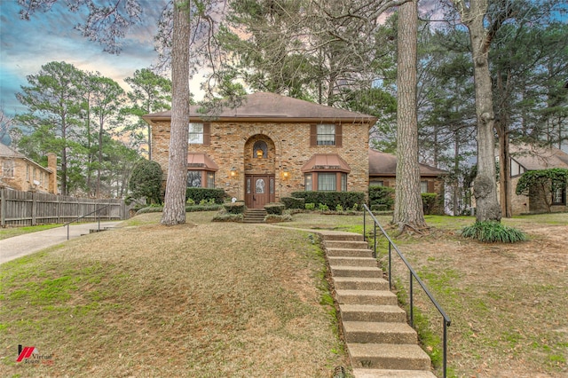 8705 Glen Haven Dr, Shreveport, LA 71106 - view of front facade featuring brick siding, a front yard, fence, and roof with shingles