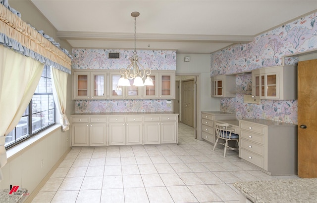 kitchen featuring light tile patterned flooring, a chandelier, hanging light fixtures, beamed ceiling, and cream cabinets