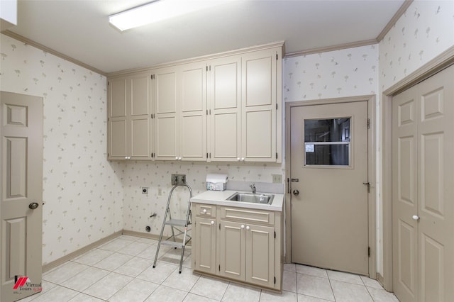 washroom with light tile patterned flooring, sink, cabinets, ornamental molding, and washer hookup