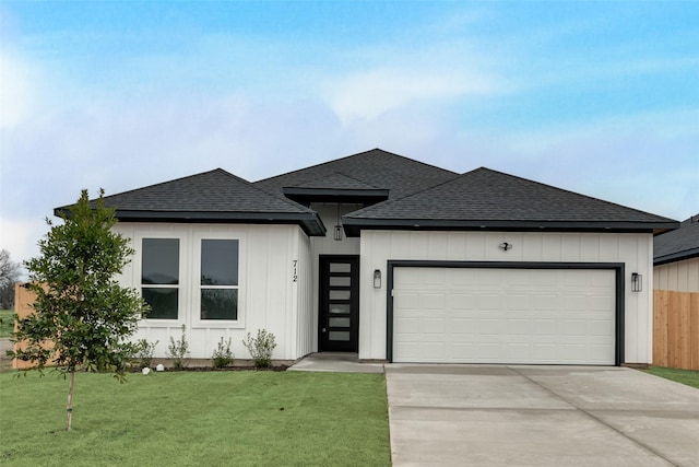 prairie-style house with a garage and a front yard