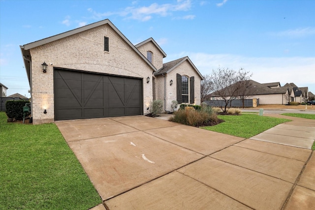 view of front of property with a garage and a front lawn