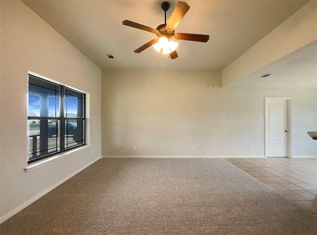 unfurnished room with tile patterned flooring and ceiling fan