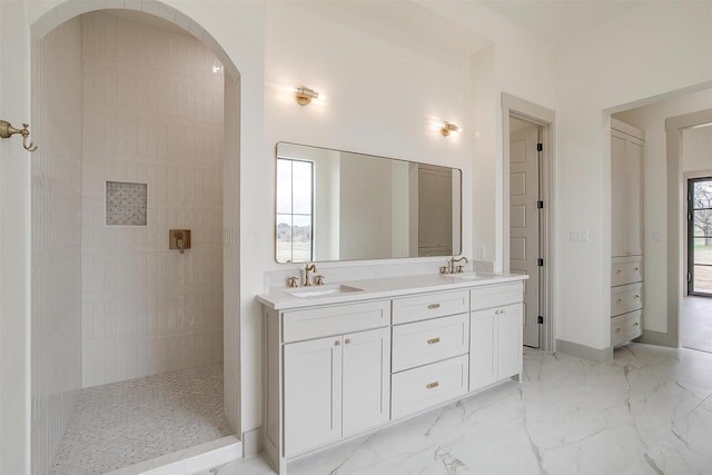 bathroom with vanity and tiled shower