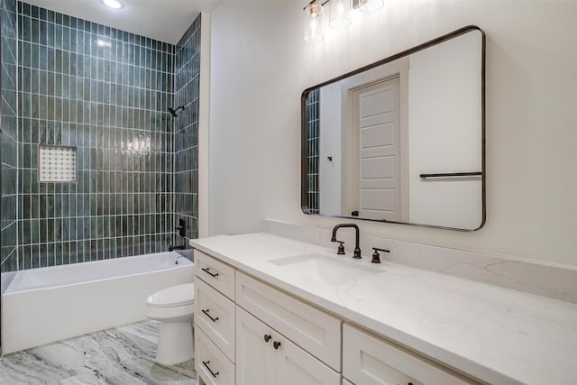 full bathroom with vanity, toilet, and tiled shower / bath