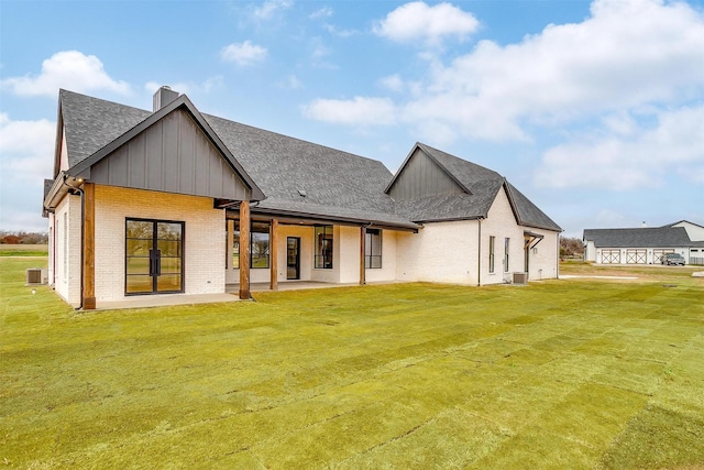 rear view of house featuring a yard and a patio area