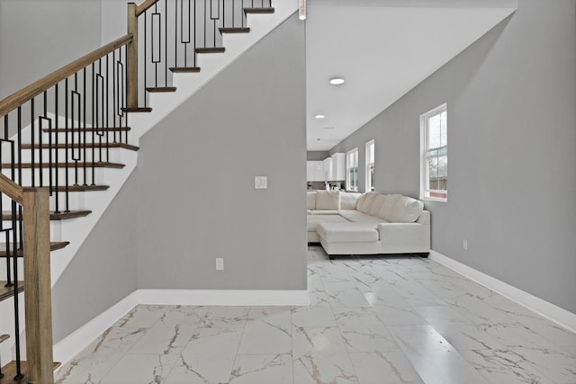 stairs featuring a high ceiling