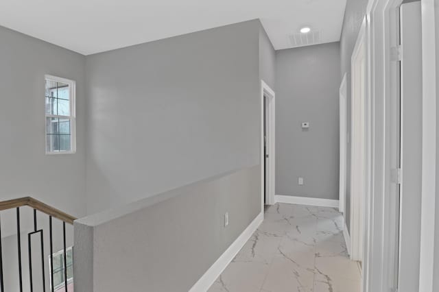 hallway featuring marble finish floor, visible vents, and baseboards