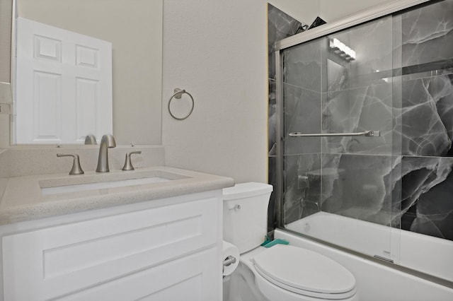 full bathroom with toilet, enclosed tub / shower combo, and vanity