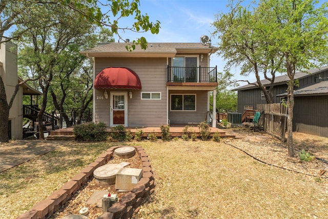 rear view of property with central AC, a balcony, and a deck