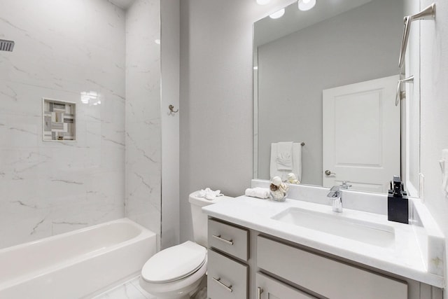 full bathroom featuring tiled shower / bath, vanity, and toilet