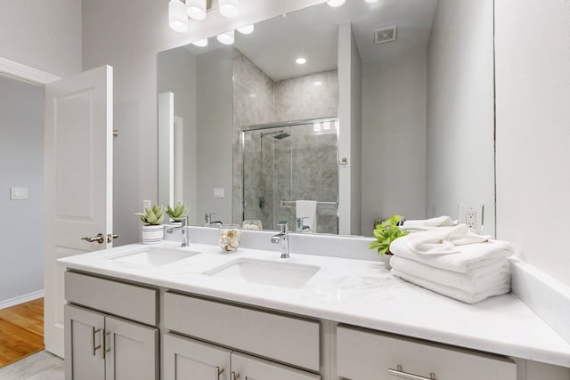 bathroom with vanity, an enclosed shower, and hardwood / wood-style floors