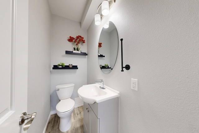 bathroom with vanity, hardwood / wood-style floors, and toilet