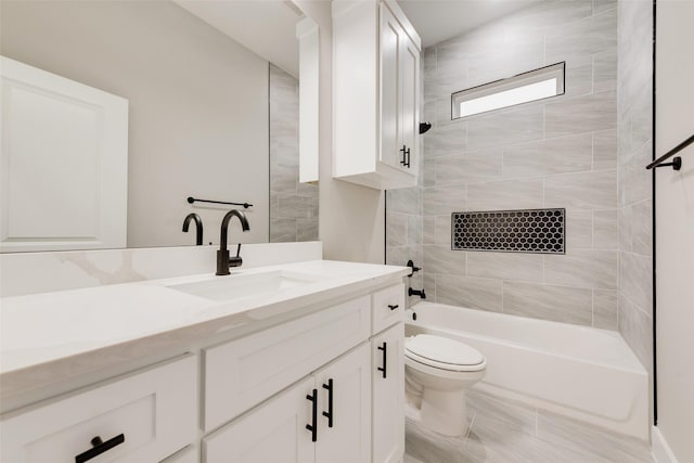 full bathroom with vanity, tiled shower / bath, and toilet