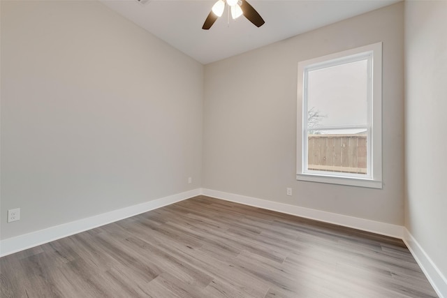 empty room with light hardwood / wood-style flooring and ceiling fan