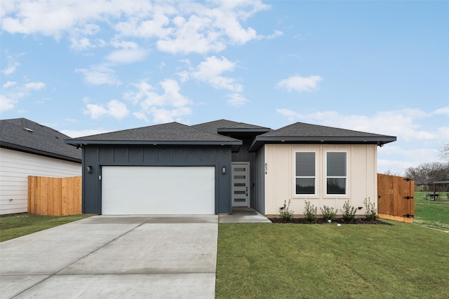 view of front of home featuring a garage and a front lawn