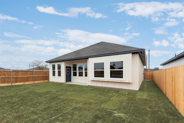 rear view of house featuring a lawn