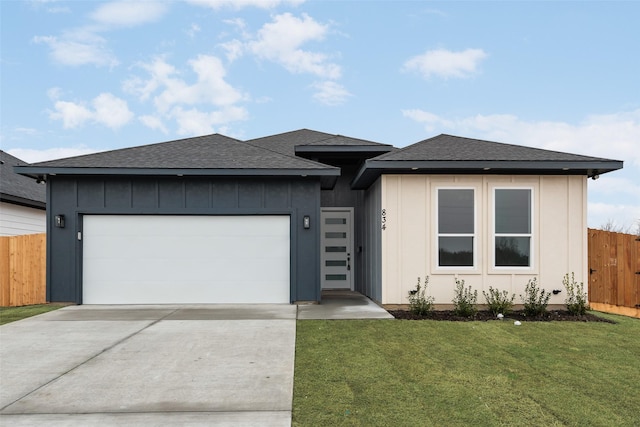 view of front of house with a garage and a front yard