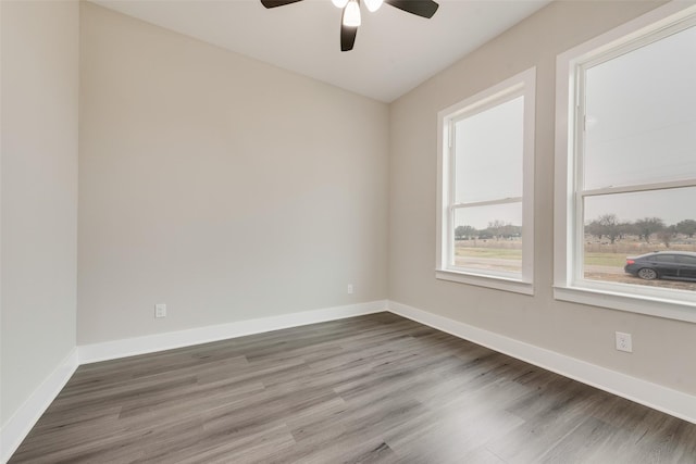 unfurnished room featuring dark hardwood / wood-style floors and ceiling fan