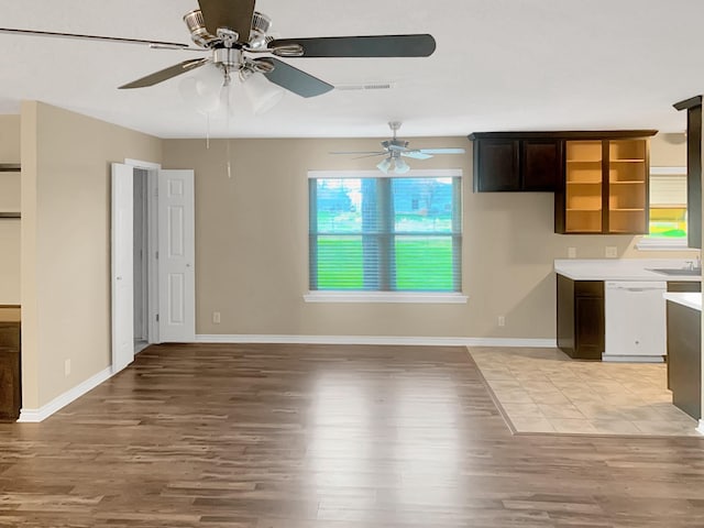 interior space with white dishwasher, hardwood / wood-style flooring, and dark brown cabinetry