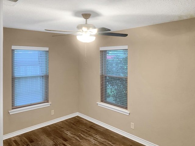 spare room featuring hardwood / wood-style floors and ceiling fan