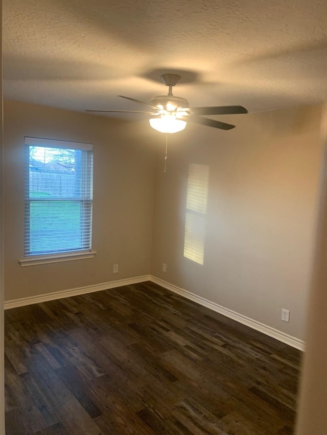 unfurnished room with ceiling fan, dark hardwood / wood-style floors, and a textured ceiling