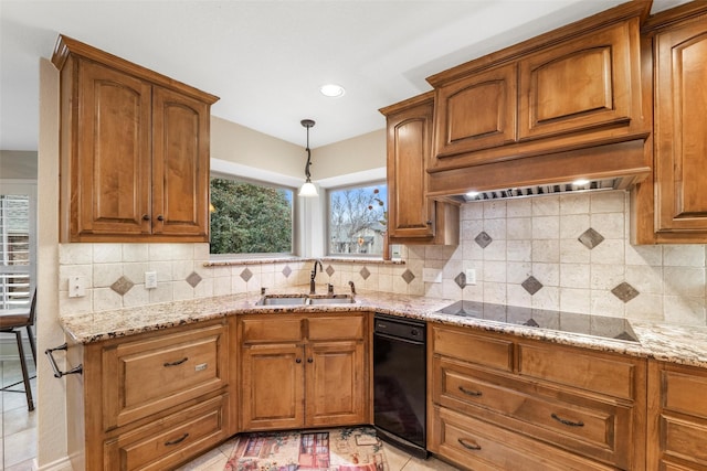 kitchen with light stone counters, sink, tasteful backsplash, and black electric stovetop