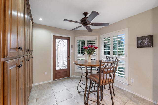 dining area with ceiling fan and light tile patterned floors