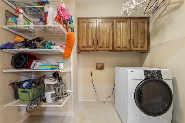 laundry area featuring cabinets and washer / dryer