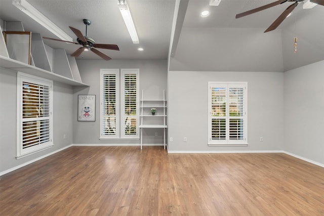 empty room featuring ceiling fan, a healthy amount of sunlight, and light hardwood / wood-style flooring