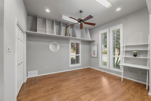 spare room featuring hardwood / wood-style flooring and ceiling fan