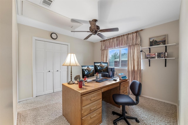 office space featuring light carpet and ceiling fan