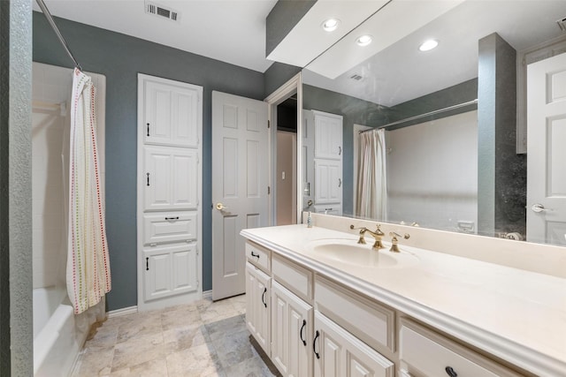 bathroom featuring vanity and shower / bath combination with curtain