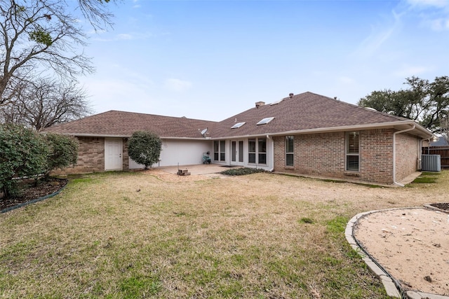 back of property with cooling unit, a patio area, and a lawn