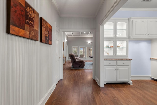 corridor featuring ornamental molding and dark hardwood / wood-style floors