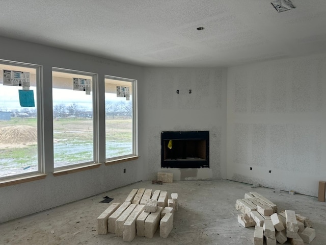 unfurnished living room featuring a textured ceiling