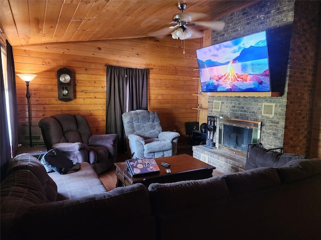 3929 San Saba St, Athens, TX 75752 - living area with vaulted ceiling, ceiling fan, a fireplace, wooden walls, and wood finished floors