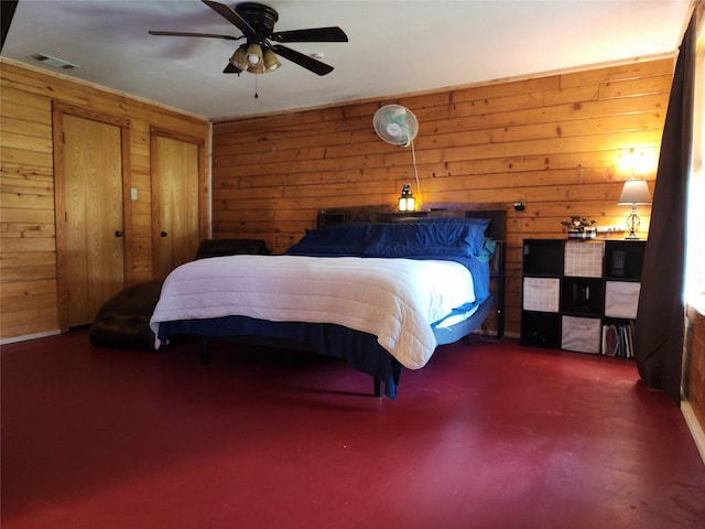 3929 San Saba St, Athens, TX 75752 - bedroom with wooden walls, finished concrete floors, and a ceiling fan