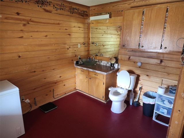 3929 San Saba St, Athens, TX 75752 - bathroom featuring toilet, wood walls, and vanity