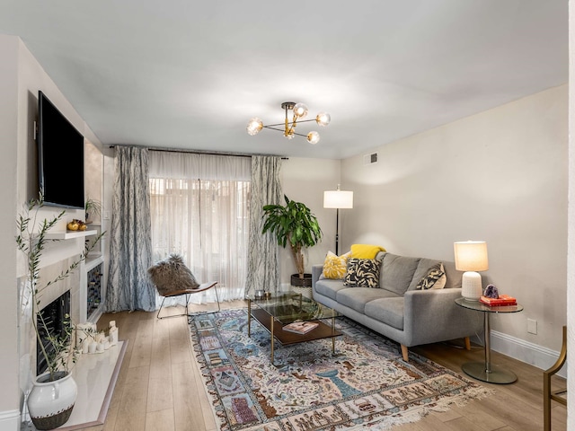 living room with a notable chandelier and hardwood / wood-style flooring