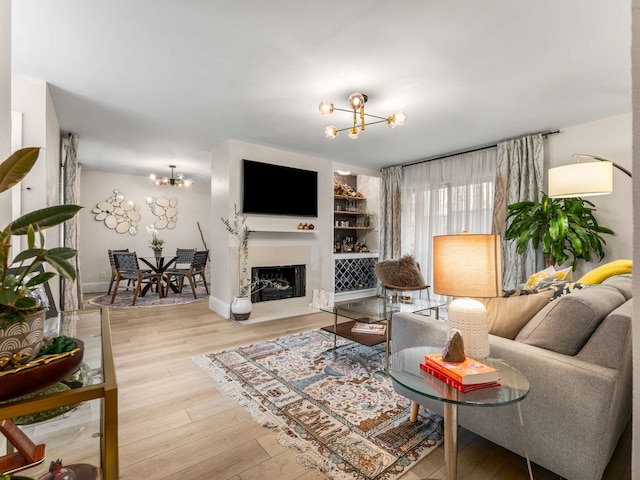 living room with an inviting chandelier and hardwood / wood-style floors