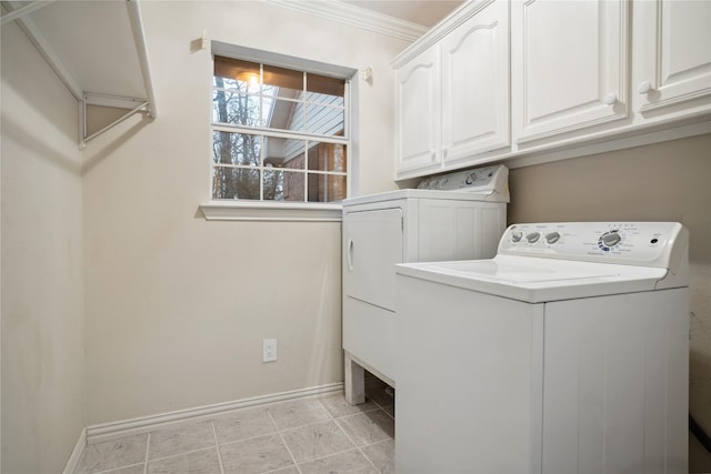 washroom with cabinets, washing machine and dryer, ornamental molding, and light tile patterned floors