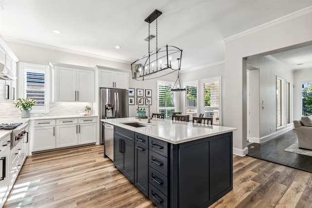 kitchen with white cabinets, stainless steel appliances, light countertops, light wood-type flooring, and a sink