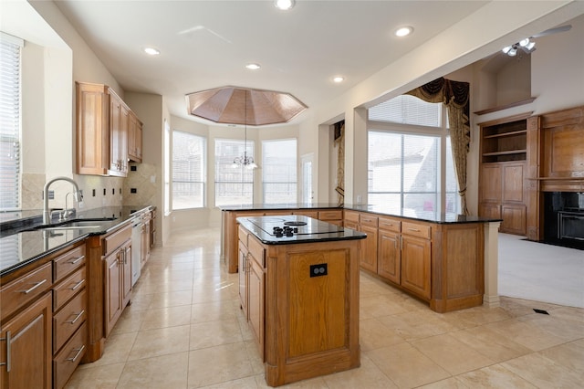 kitchen with light tile patterned floors, a peninsula, a sink, a center island, and tasteful backsplash