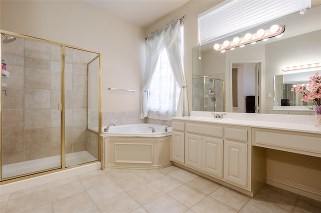 bathroom with a garden tub, a shower stall, tile patterned flooring, and vanity