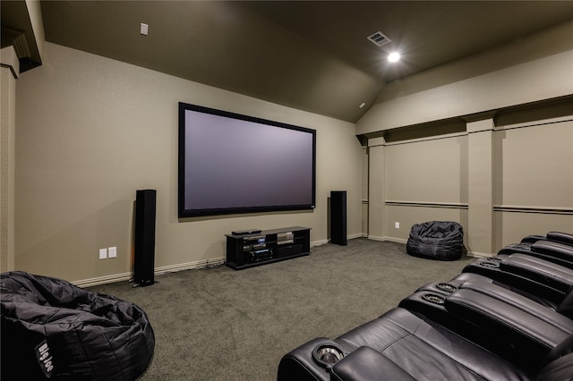 carpeted cinema room featuring lofted ceiling, visible vents, and baseboards